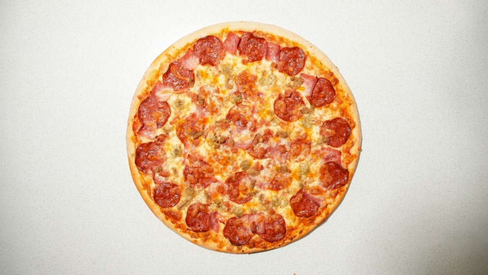 Pizza Bono Meat Lover pizza fresh from the oven, loaded with pepperoni, sausage, beef and bacon